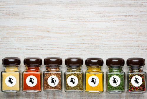 Glass spice jars with WayAround Stickers on the front.